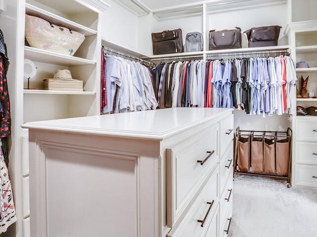 4805 116th Street Lubbock, TX 79424 - Photo 22 of 57 a view of walk in closet with clothes and shoes