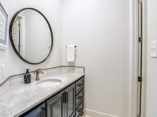 4805 116th Street Lubbock, TX 79424 - Photo 28 of 57 a bathroom with a granite countertop sink and a mirror