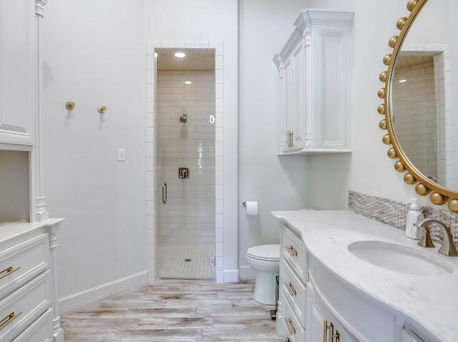 4805 116th Street Lubbock, TX 79424 - Photo 30 of 57 a bathroom with a sink toilet and shower a mirror