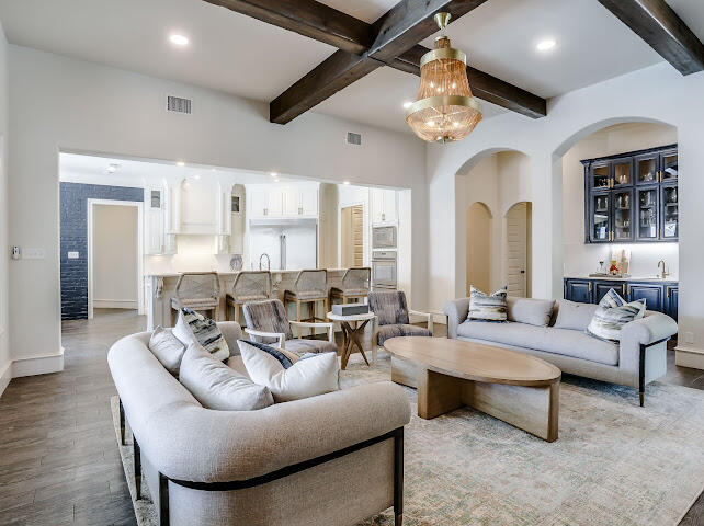 4805 116th Street Lubbock, TX 79424 - Photo 6 of 57 a living room with furniture a chandelier and a large window
