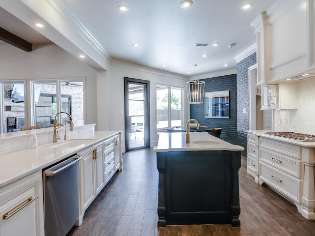 4805 116th Street Lubbock, TX 79424 - Photo 10 of 57 a large kitchen with kitchen island a sink a stove and a refrigerator