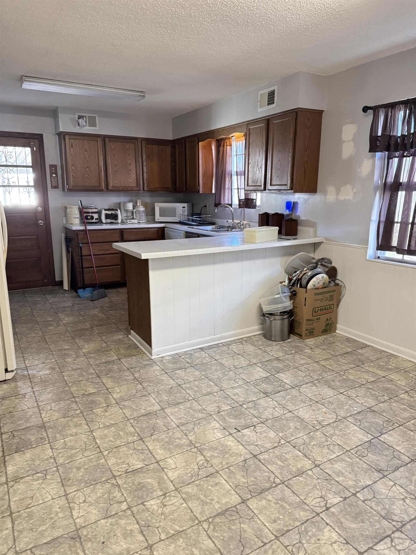 4112 Vaughn Road Memphis, TN 38122 - Photo 3 of 12 a kitchen with stainless steel appliances granite countertop a sink stove and cabinets