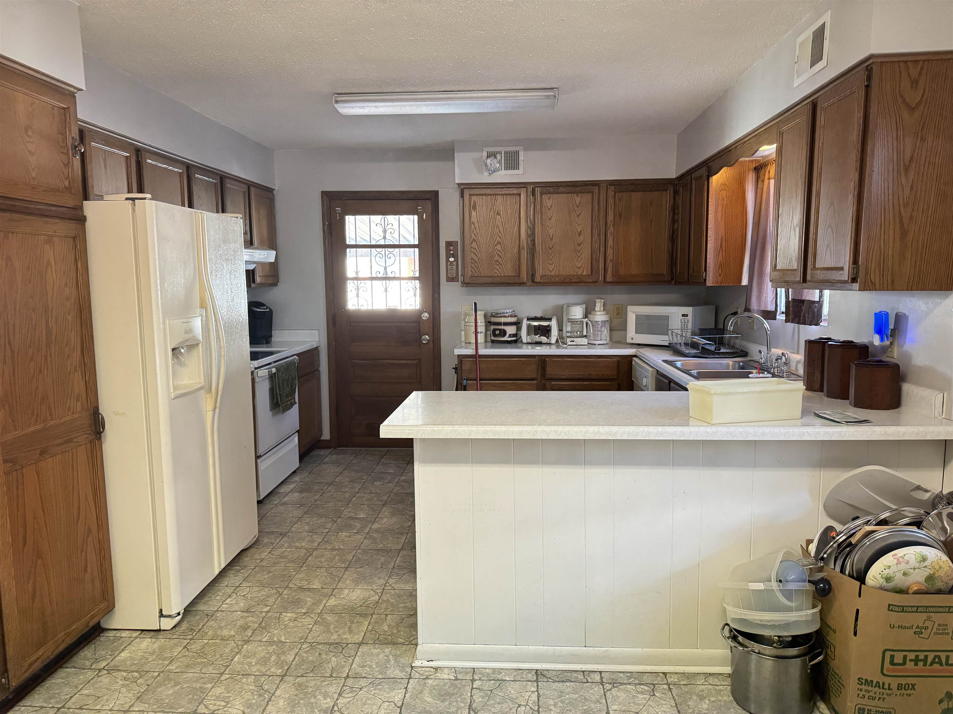 4112 Vaughn Road Memphis, TN 38122 - Photo 5 of 12 a kitchen with a refrigerator and a sink