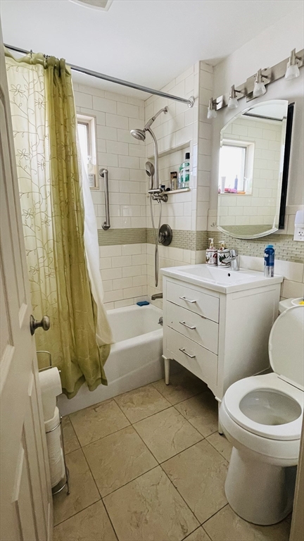 70 Putnam Road, Unit 1 Somerville, MA 02145 - Photo 6 of 11 a bathroom with a sink toilet and shower