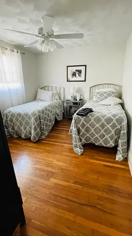 a bedroom with double vanity and a bed