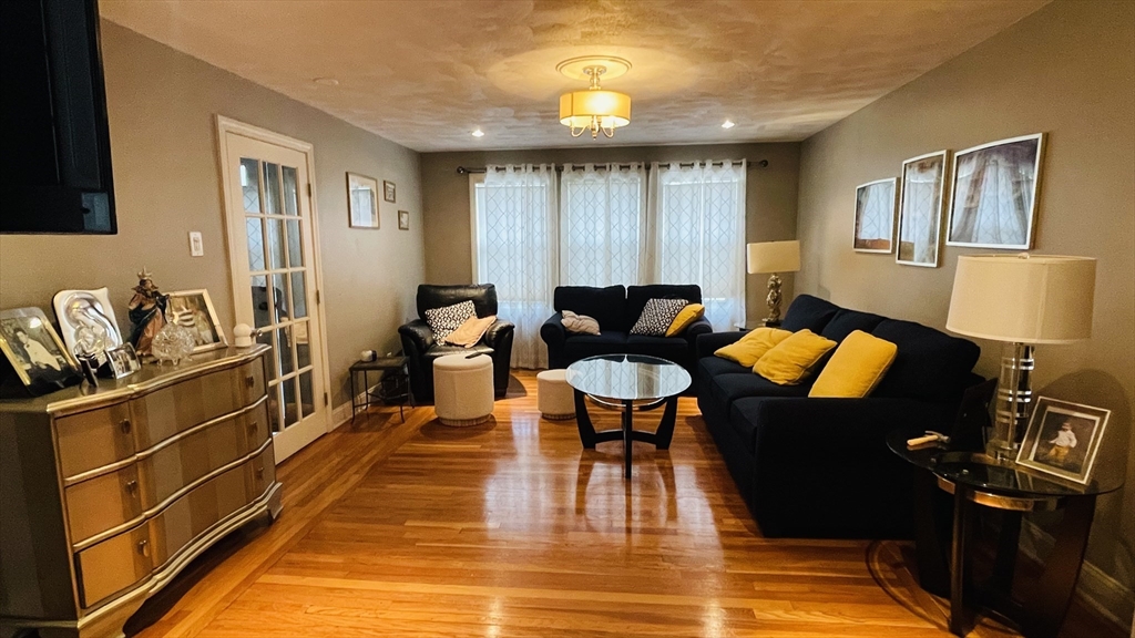 70 Putnam Road, Unit 1 Somerville, MA 02145 - Photo 9 of 11 a living room with furniture a lamp wooden floor and a table