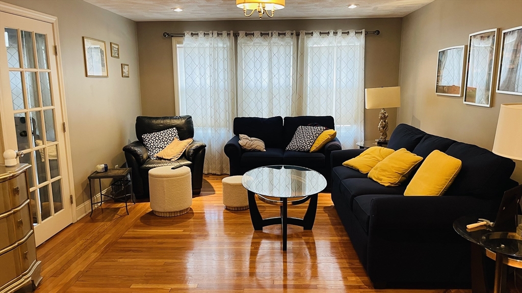 70 Putnam Road, Unit 1 Somerville, MA 02145 - Photo 10 of 11 a living room with furniture and a wooden floor