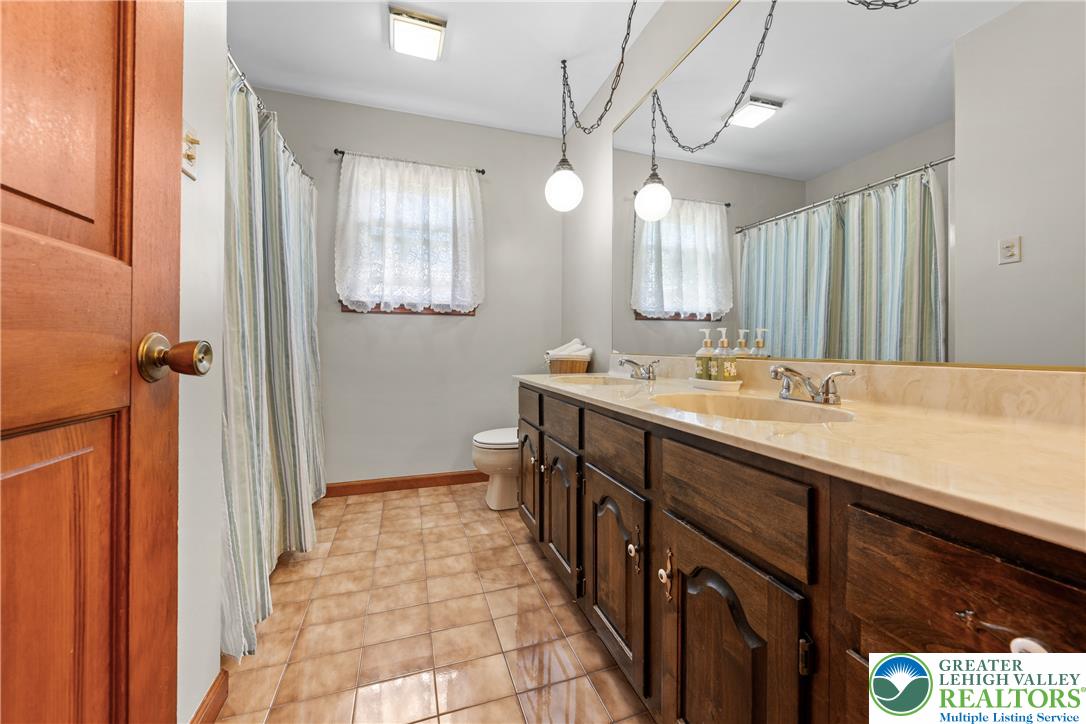 947 Tamenend Road Bath, PA 18014 - Photo 28 of 61 Double vanity with ample storage highlights this well-appointed bathroom.