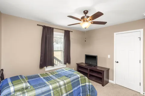 a bedroom with a bed and a chandelier