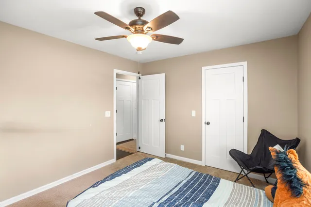 a bedroom with a bed and a chandelier