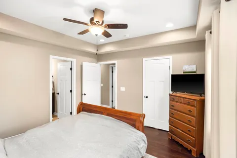 a bedroom with a bed and a ceiling fan