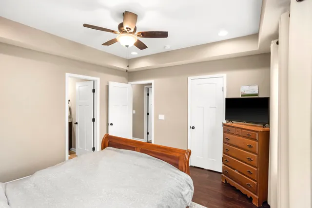 a bedroom with a bed and a ceiling fan
