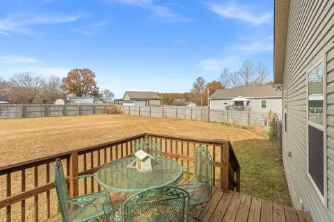 a view of a balcony with lake view and wooden floor