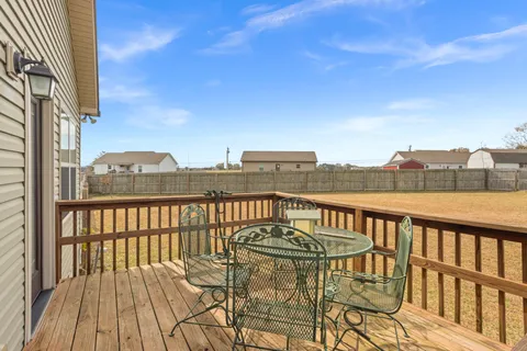 a view of a balcony with wooden floor and city view