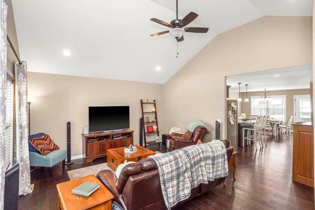 a living room with furniture flat screen tv and wooden floor