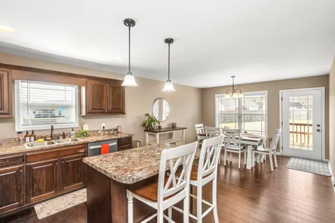 a kitchen with lots of counter space a sink appliances and dining table