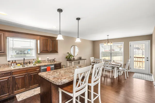 a kitchen with lots of counter space a sink appliances and dining table