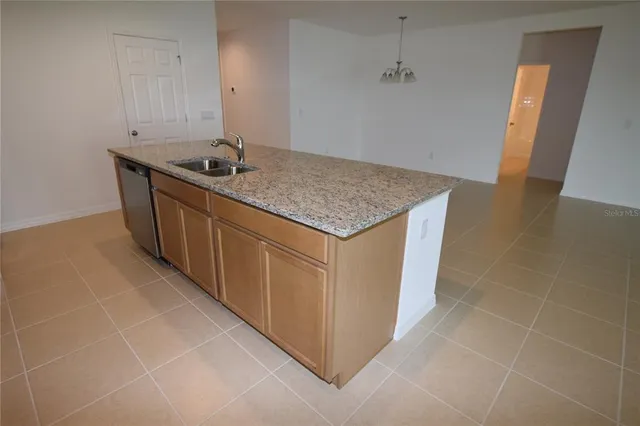 a kitchen with stainless steel appliances granite countertop a sink and a stove