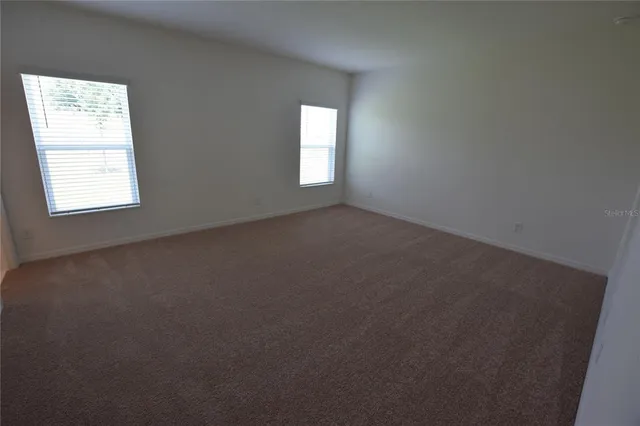an empty room that has a window in it