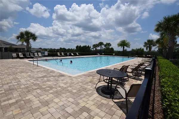 a view of a swimming pool and lake in back