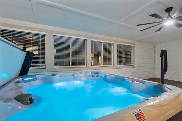 a view of an empty room with wooden floor and a bookshelf