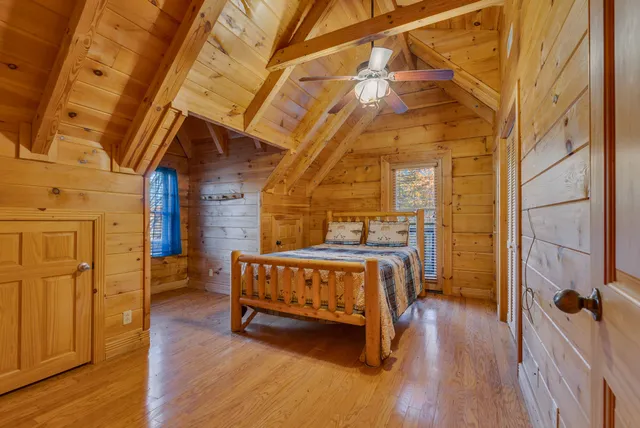 a bed sitting in a bedroom next to a bathroom