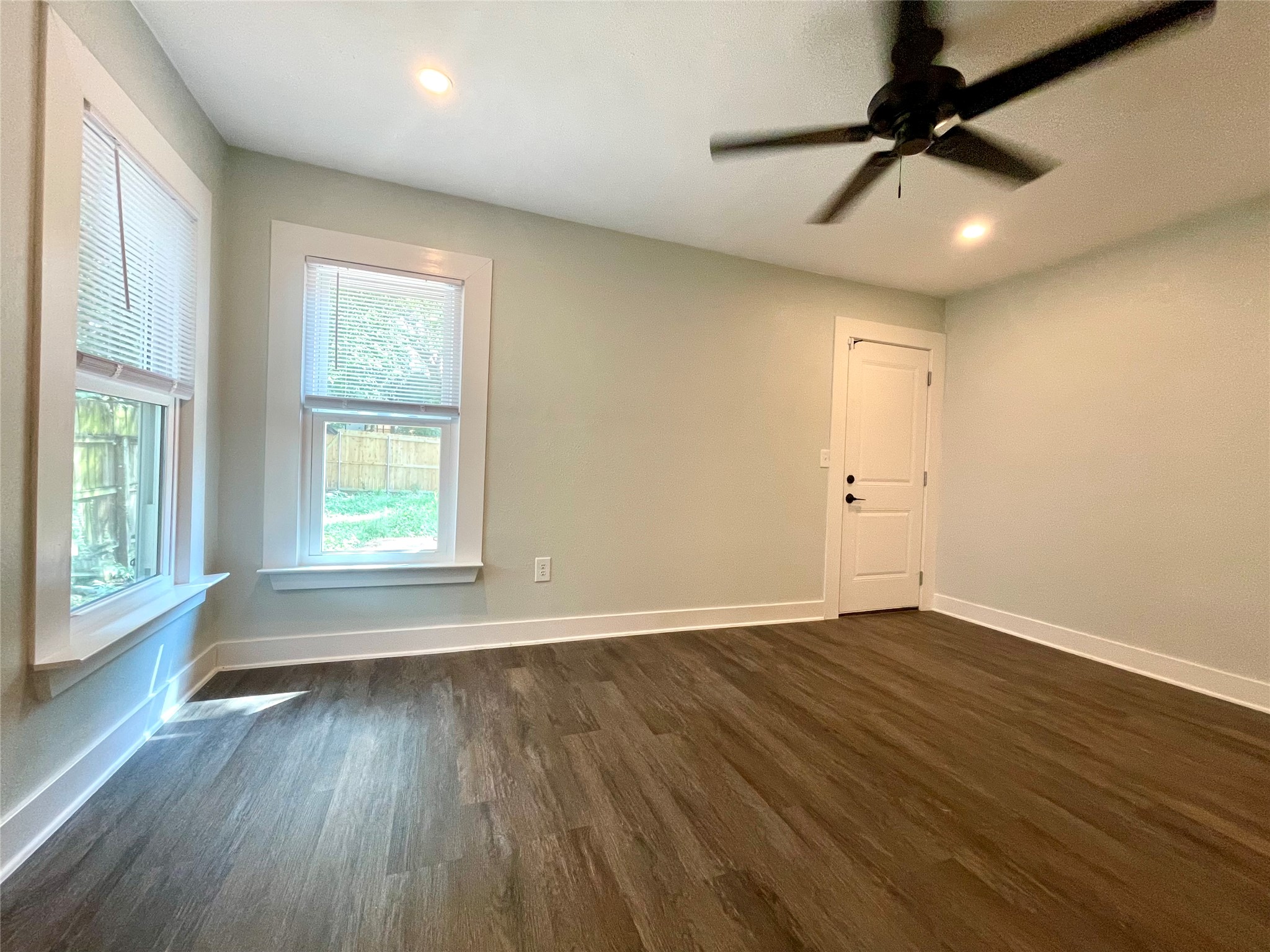 807 East Riverside Drive, Unit B Austin, TX 78704 - Photo 22 of 28 A well-lit bedroom features durable plank flooring and a modern ceiling fan for comfort.
