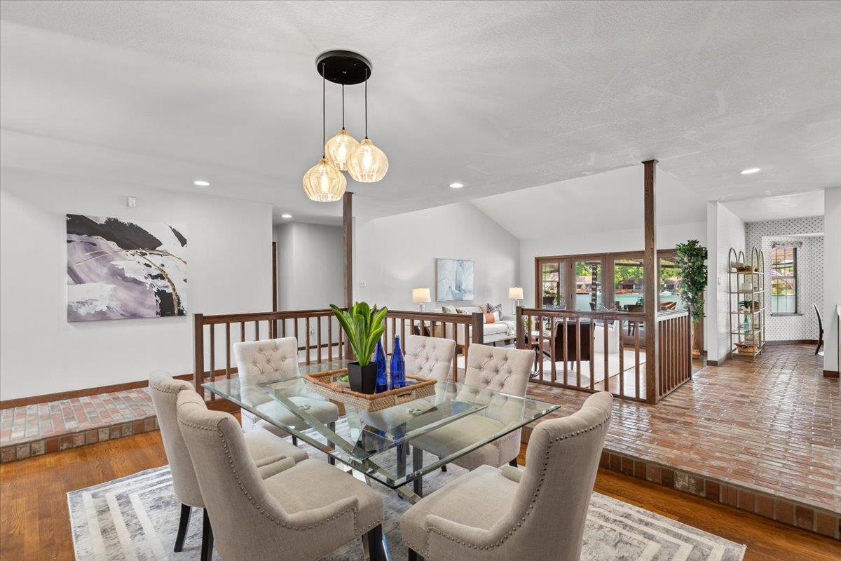 5726 Shelldrake Court Stockton, CA 95207 - Photo 17 of 89 a view of a dining room and livingroom with furniture wooden floor a chandelier
