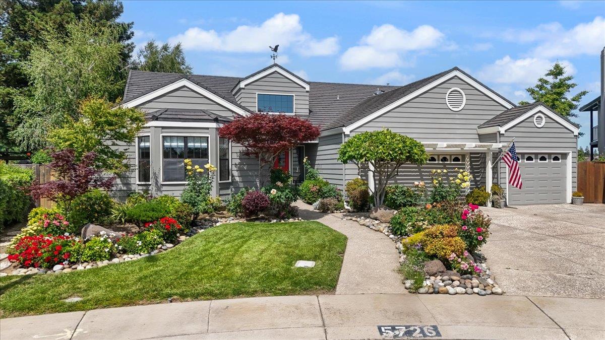 5726 Shelldrake Court Stockton, CA 95207 - Photo 2 of 89 a front view of a house with a yard and potted plants