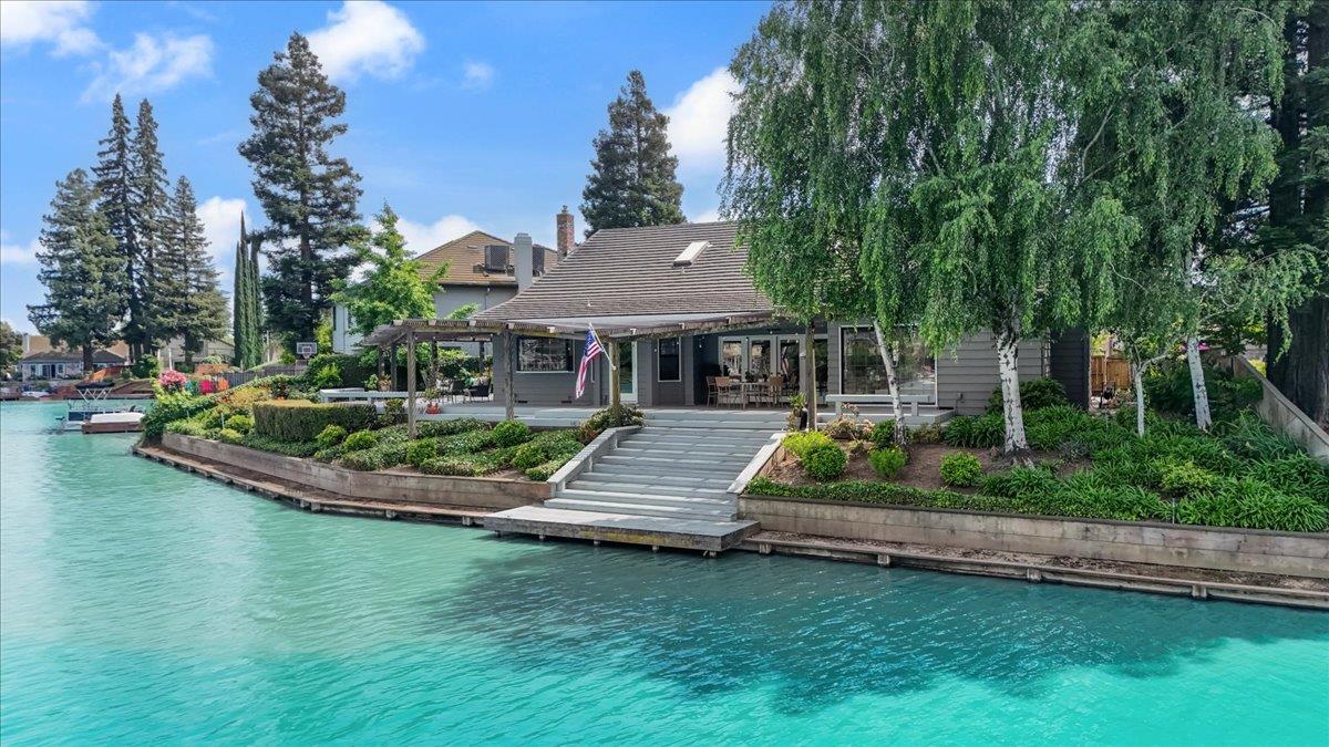 5726 Shelldrake Court Stockton, CA 95207 - Photo 5 of 89 a front view of a house with a garden and swimming pool