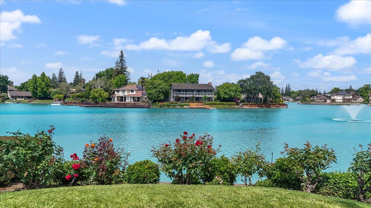 5726 Shelldrake Court Stockton, CA 95207 - Photo 79 of 89 a view of a lake with a house in the background