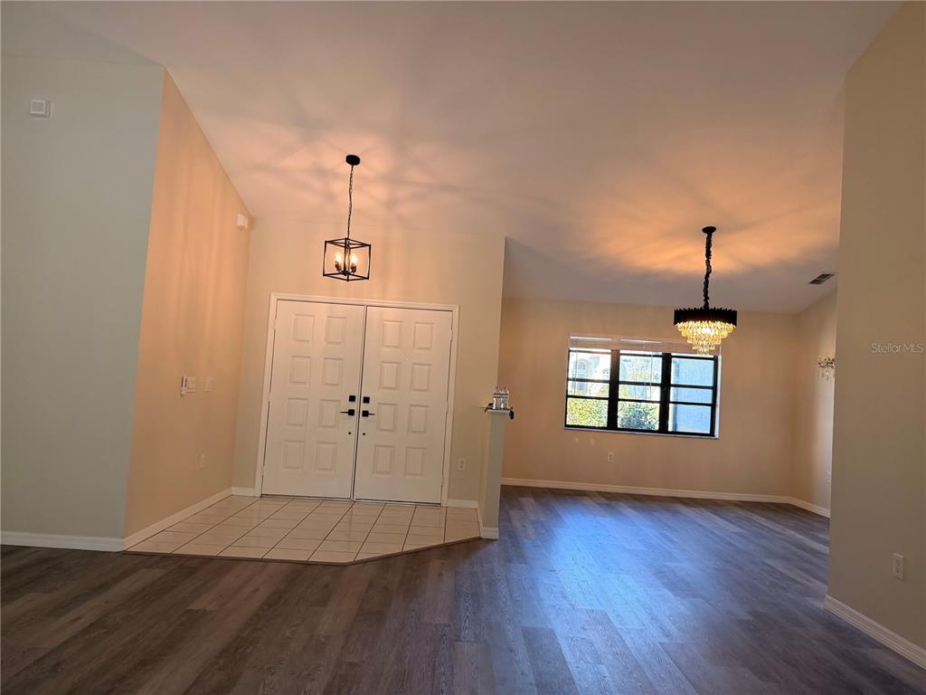 994 East Crown Of Roses Loop Inverness, FL 34453 - Photo 11 of 20 an empty room with wooden floor cabinet and windows
