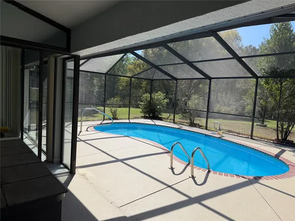 a view of a swimming pool with a lounge chair