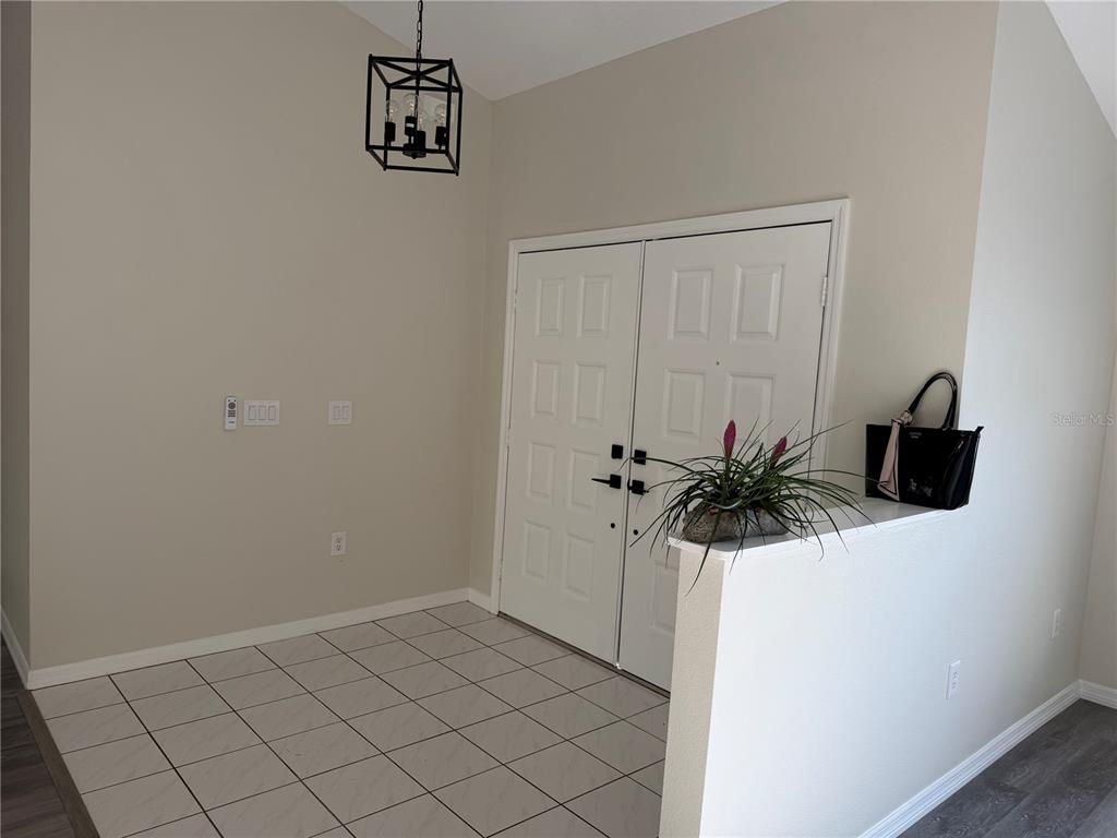 994 East Crown Of Roses Loop Inverness, FL 34453 - Photo 2 of 20 a view of a hallway with a potted plant