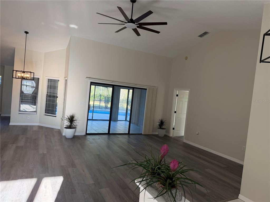 994 East Crown Of Roses Loop Inverness, FL 34453 - Photo 3 of 20 a view of an empty room with a window and wooden floor