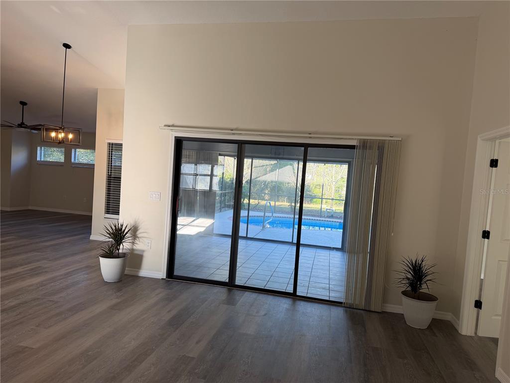 994 East Crown Of Roses Loop Inverness, FL 34453 - Photo 4 of 20 a view of an empty room with wooden floor and a window