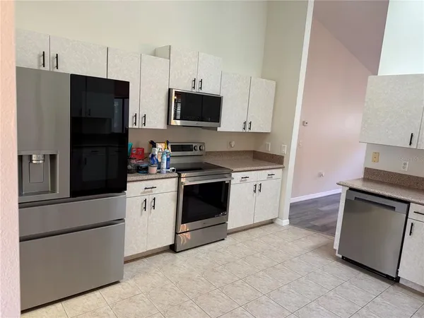 a kitchen with stainless steel appliances white cabinets and a stove