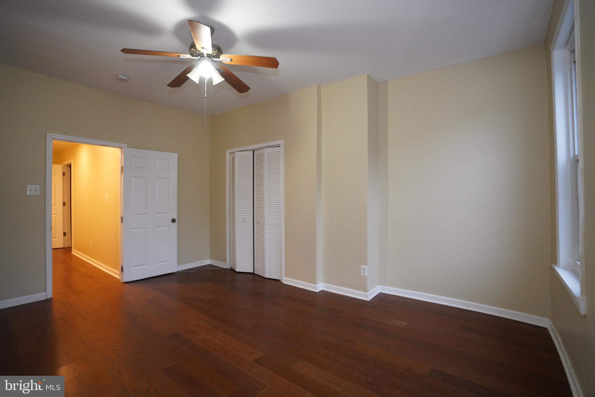 2512 North Front Street Philadelphia, PA 19133 - Photo 12 of 33 an empty room with wooden floor fan and windows