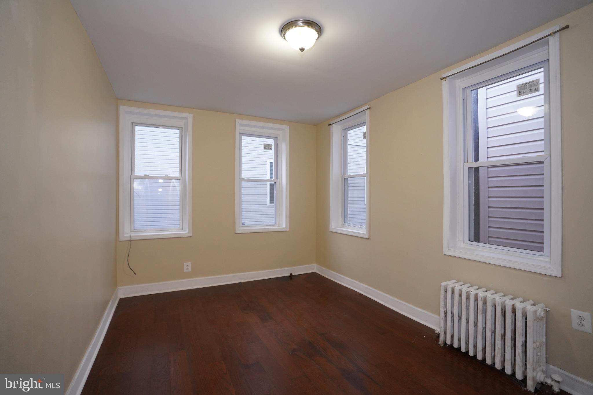2512 North Front Street Philadelphia, PA 19133 - Photo 13 of 33 a view of an empty room with wooden floor and a window