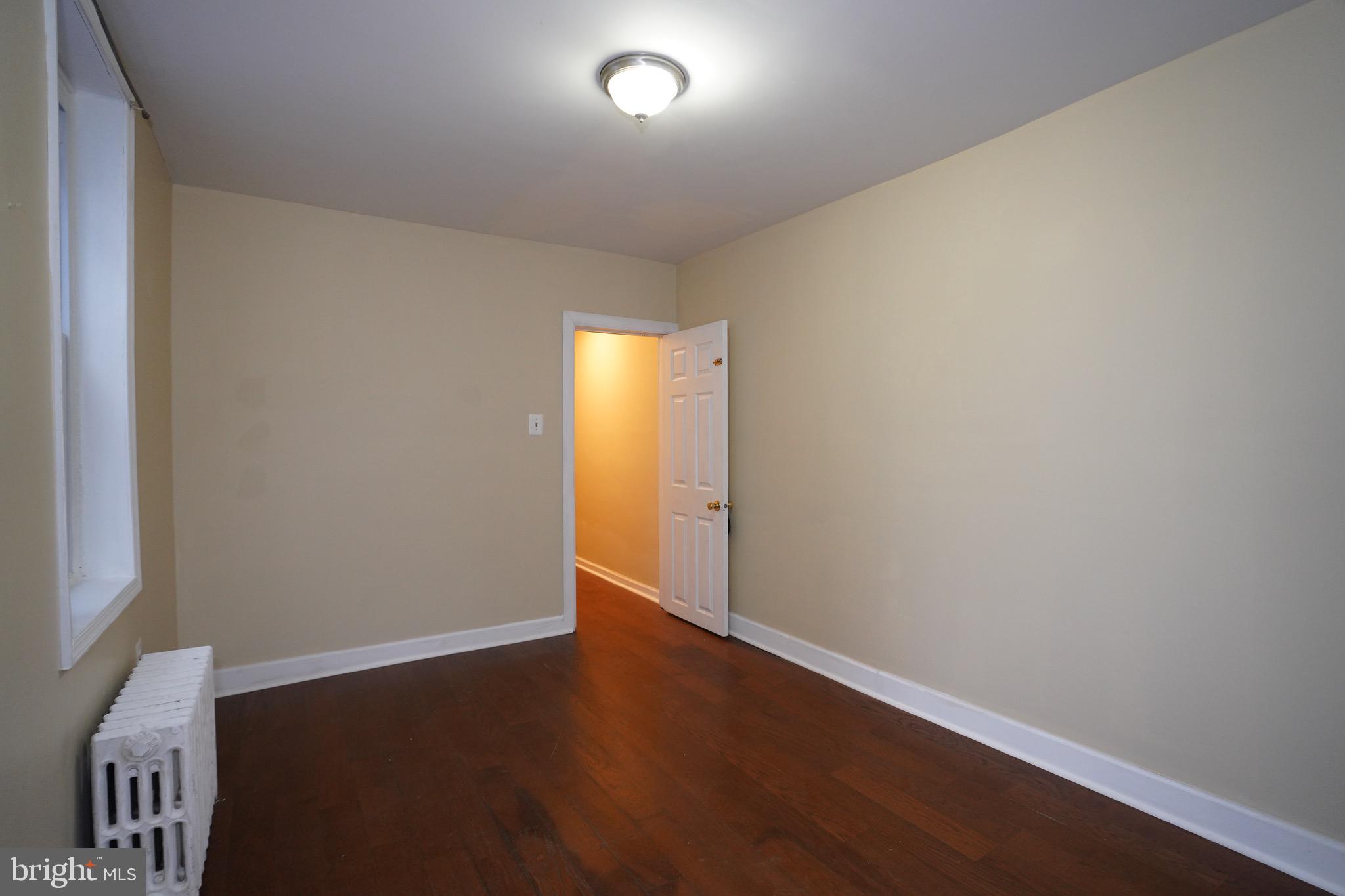 2512 North Front Street Philadelphia, PA 19133 - Photo 14 of 33 an empty room with wooden floor and windows
