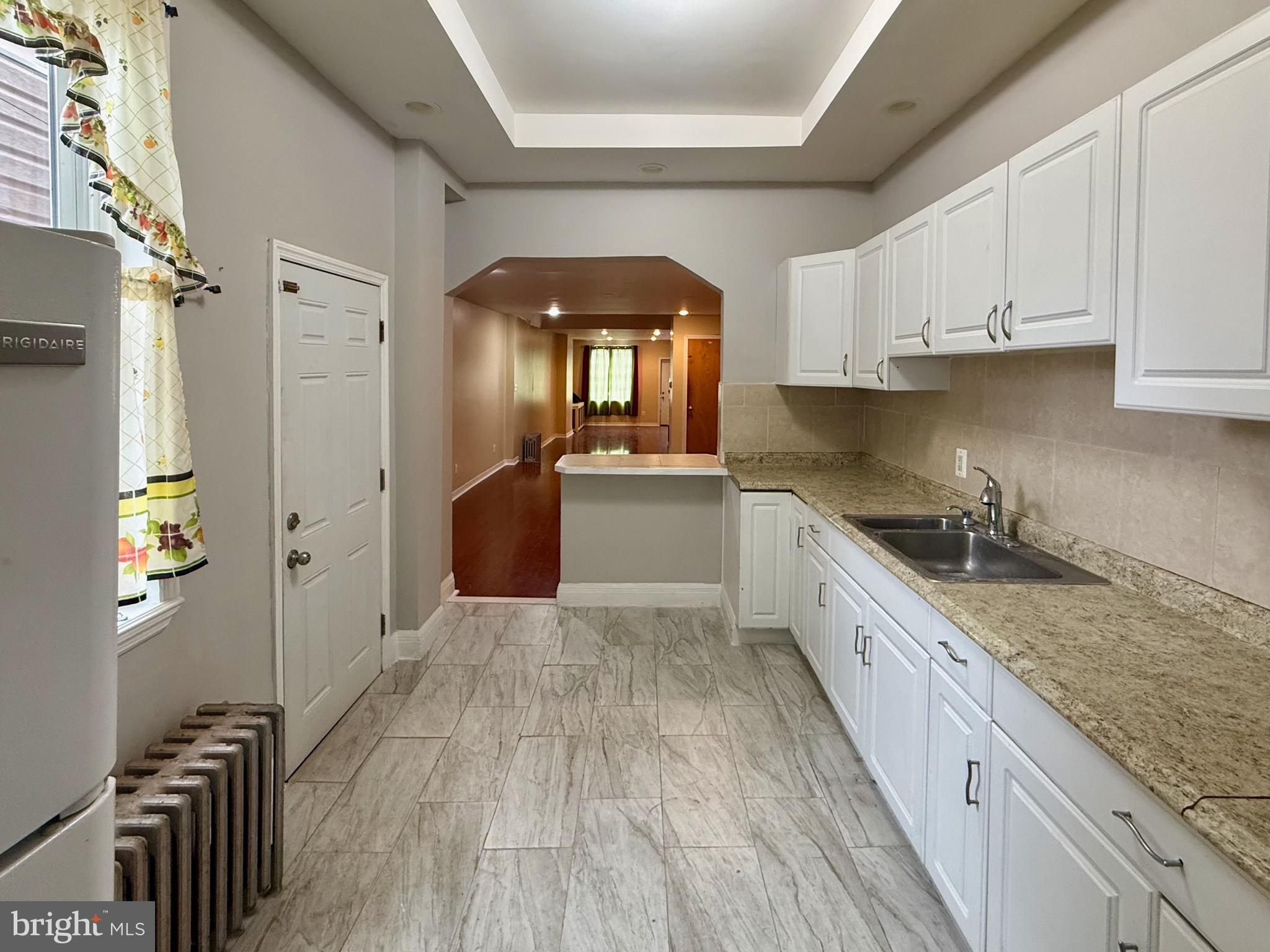 2512 North Front Street Philadelphia, PA 19133 - Photo 9 of 33 a large kitchen with stainless steel appliances granite countertop a lot of counter space and wooden floors