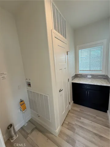 a room with a baby crib and a dresser