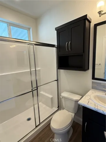 a white toilet sitting next to a bathroom sink
