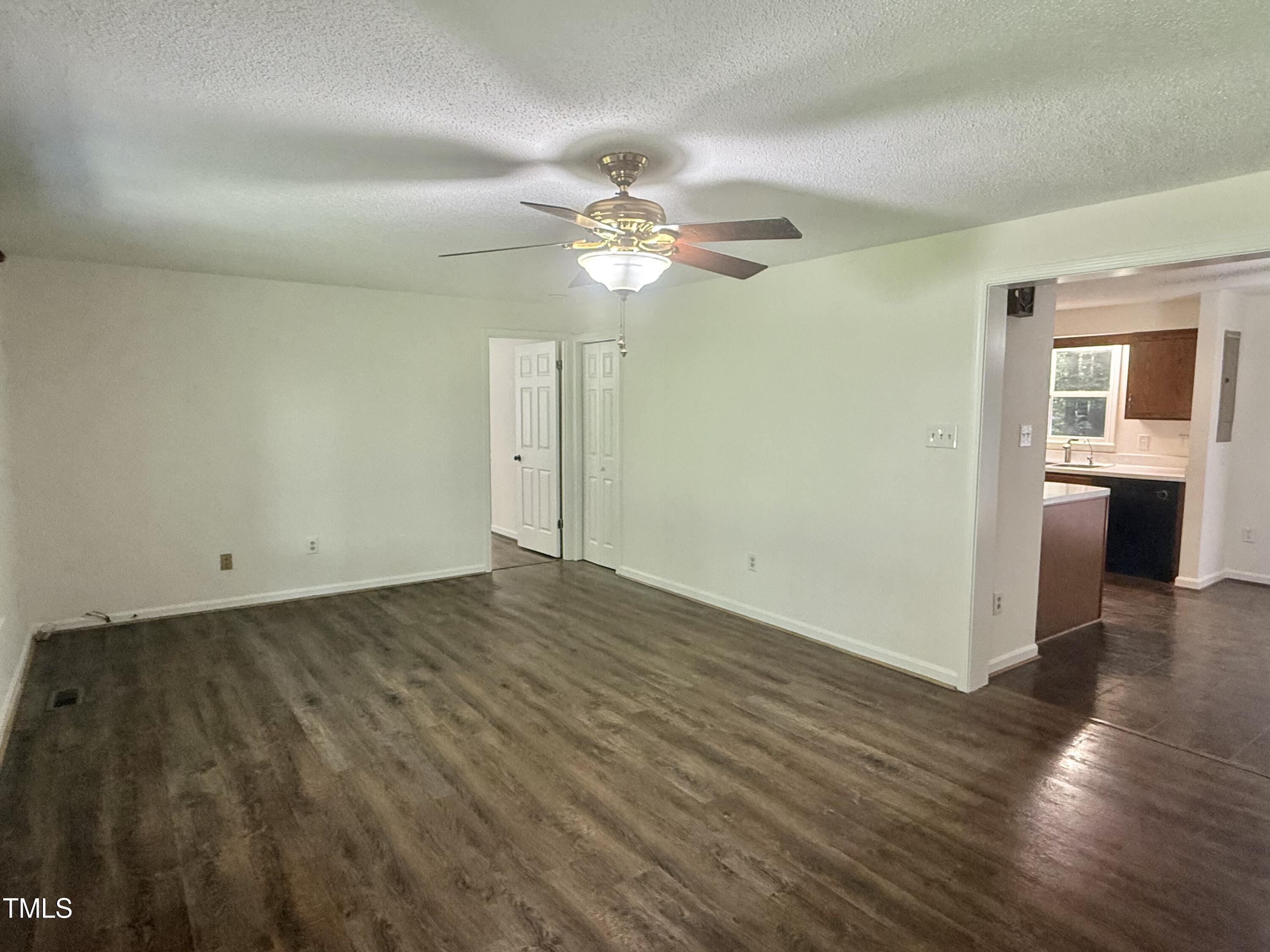 192 Misty Hollow Road Timberlake, NC 27583 - Photo 15 of 43 a view of a livingroom with wooden floor and a ceiling fan