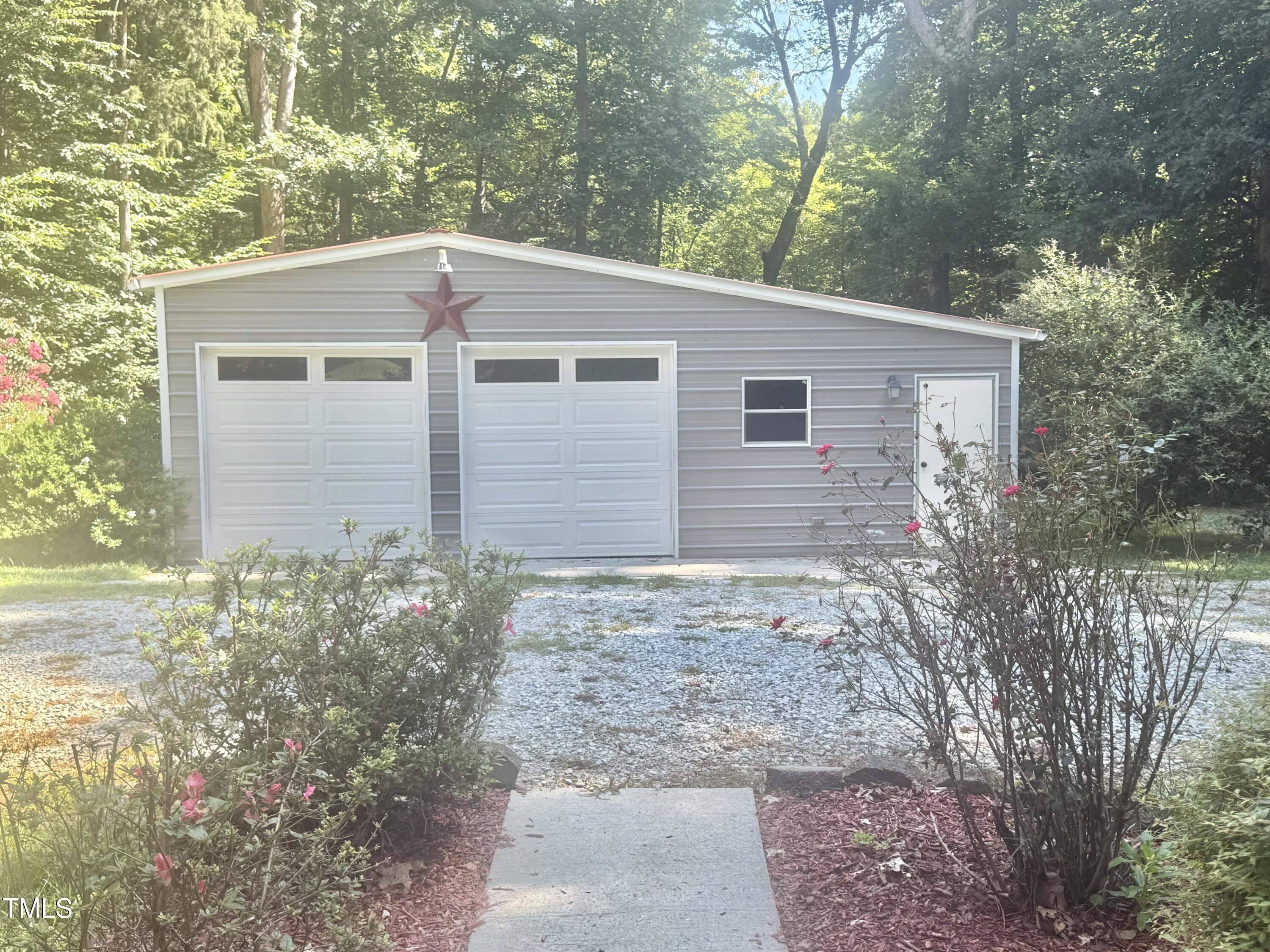 192 Misty Hollow Road Timberlake, NC 27583 - Photo 2 of 43 a front view of a house with garden