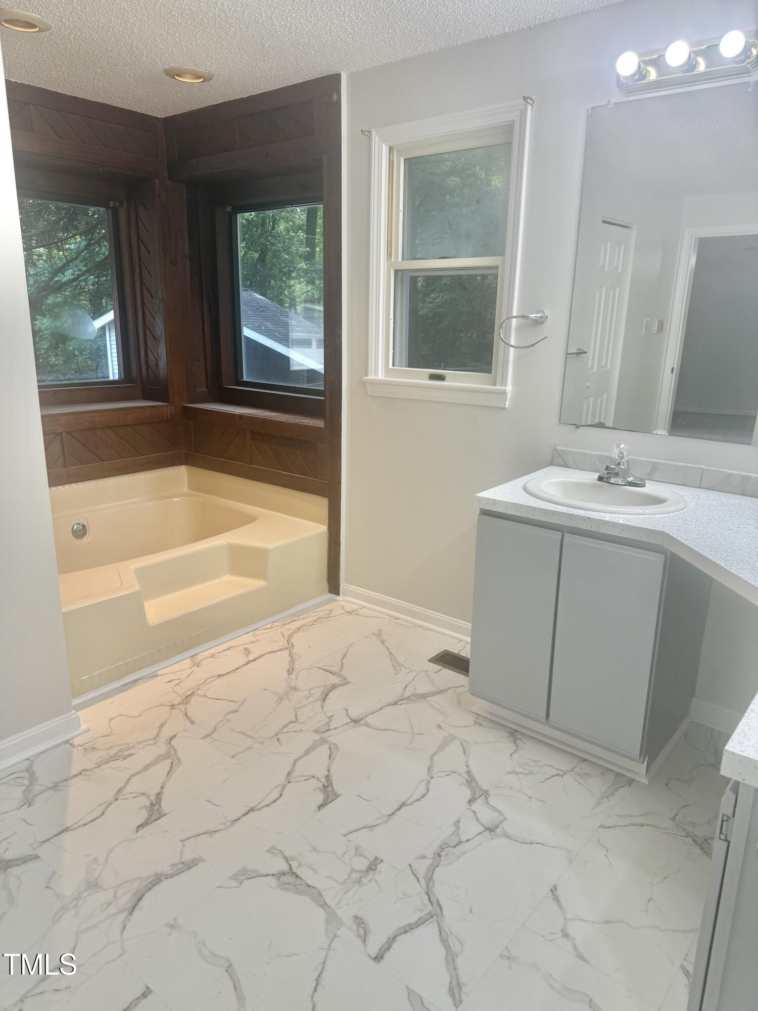 192 Misty Hollow Road Timberlake, NC 27583 - Photo 21 of 43 a bathroom with a tub sink and window