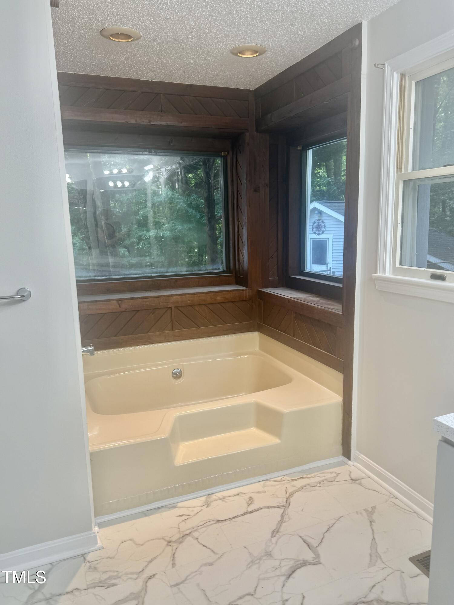 192 Misty Hollow Road Timberlake, NC 27583 - Photo 22 of 43 a bathroom with bathtub and window