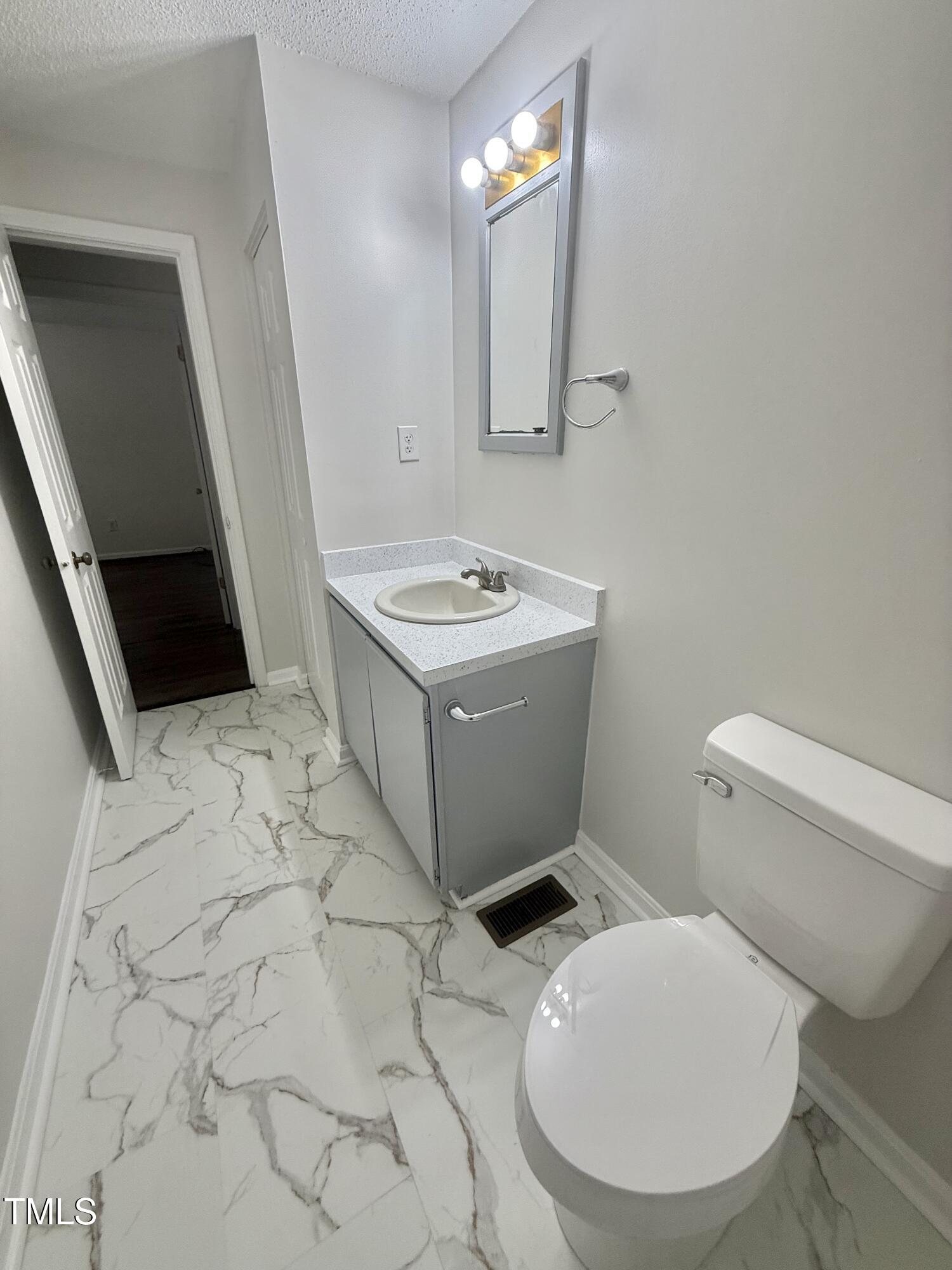 192 Misty Hollow Road Timberlake, NC 27583 - Photo 30 of 43 a bathroom with a sink toilet and mirror