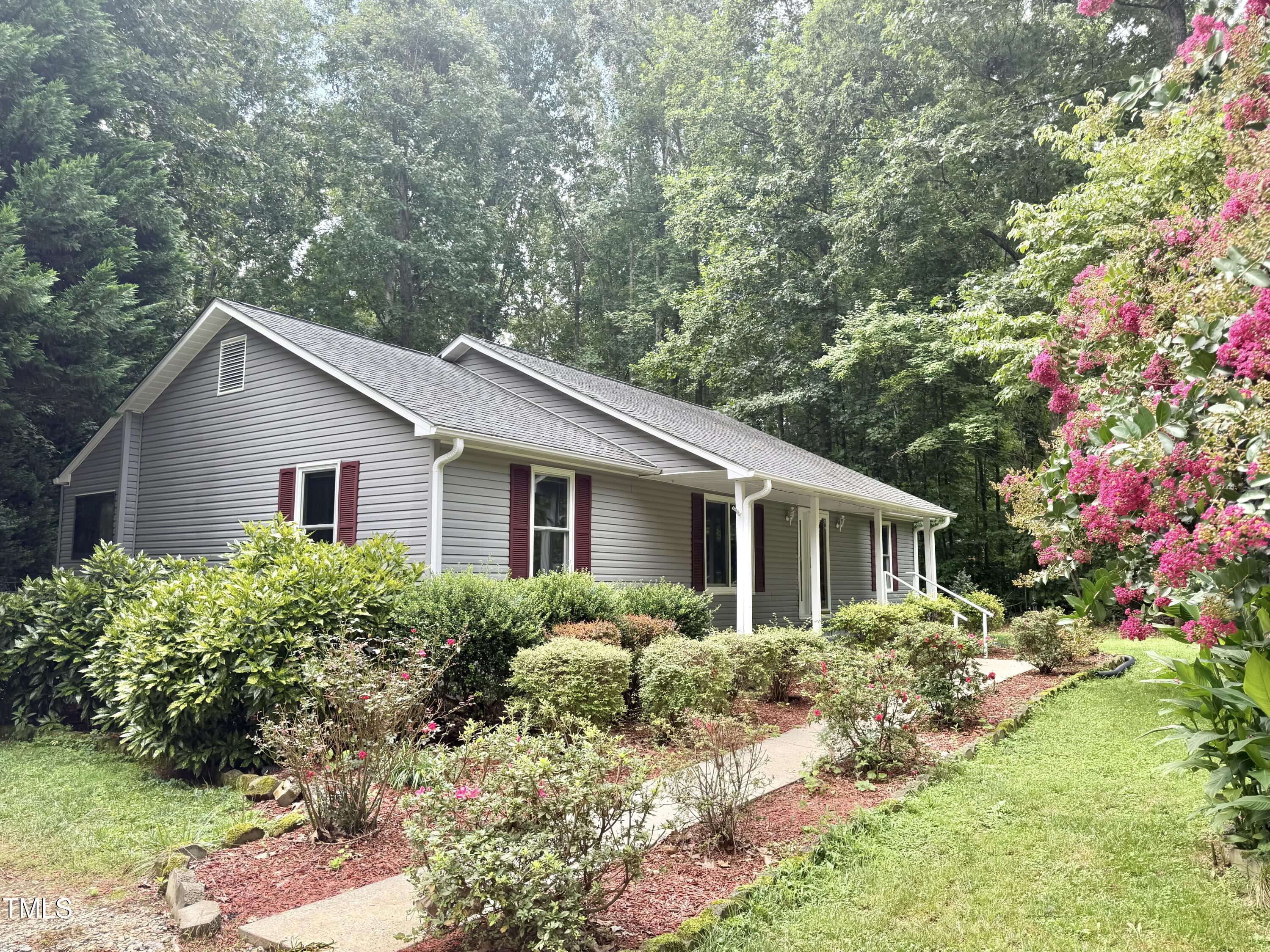 192 Misty Hollow Road Timberlake, NC 27583 - Photo 3 of 43 a view of a house with yard and garden
