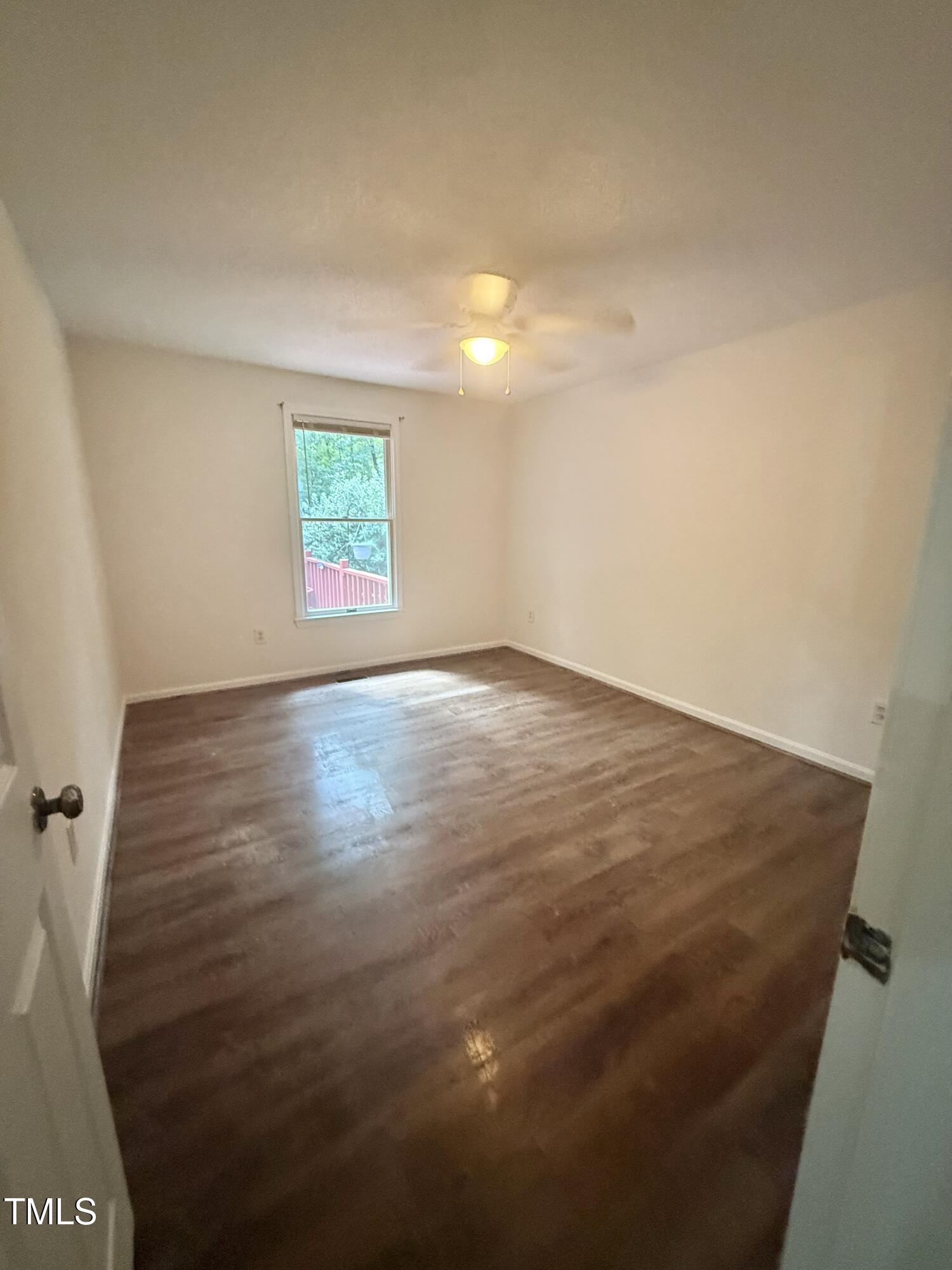 192 Misty Hollow Road Timberlake, NC 27583 - Photo 31 of 43 an empty room with wooden floor and windows